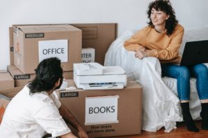 couple done packing and labeling boxes